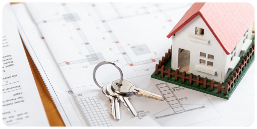 Keys on blueprint with model house